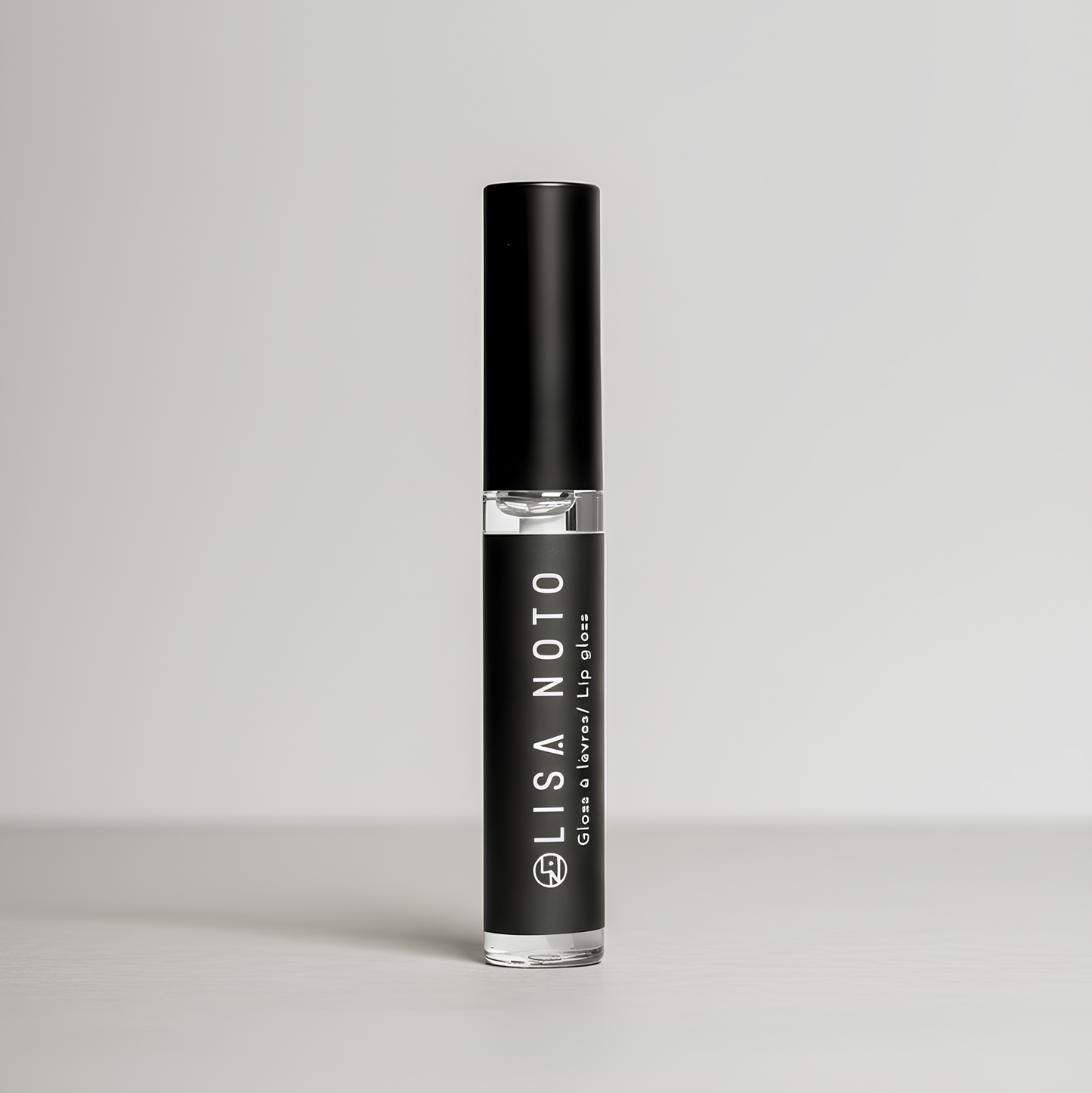Clear hydrating natural lip gloss on grey background