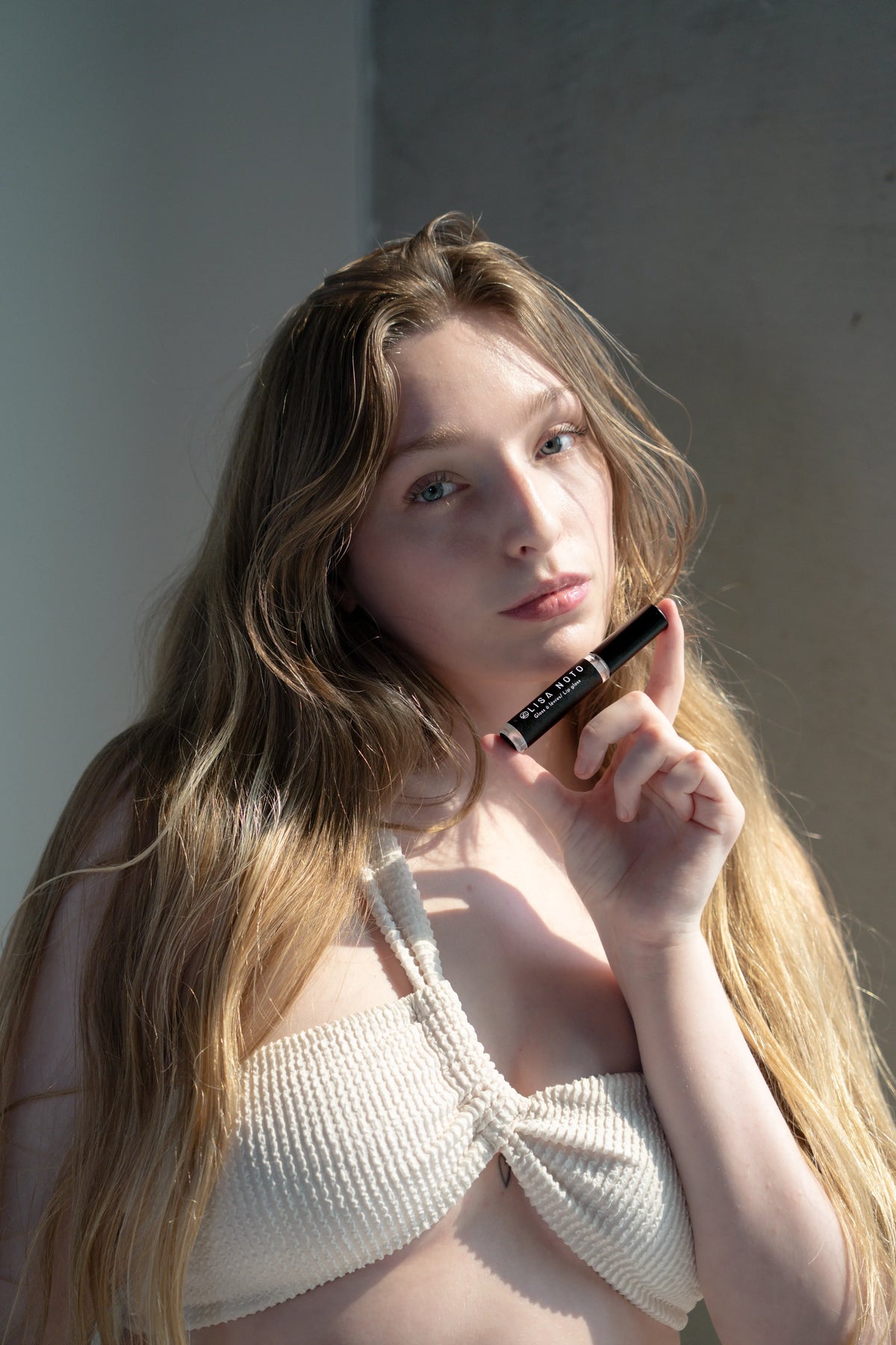 model with subtle shimmery clear hydrating lip gloss that represents elegance at it’s best. Soften, smooth and plump with hydration for visibly fuller lips.