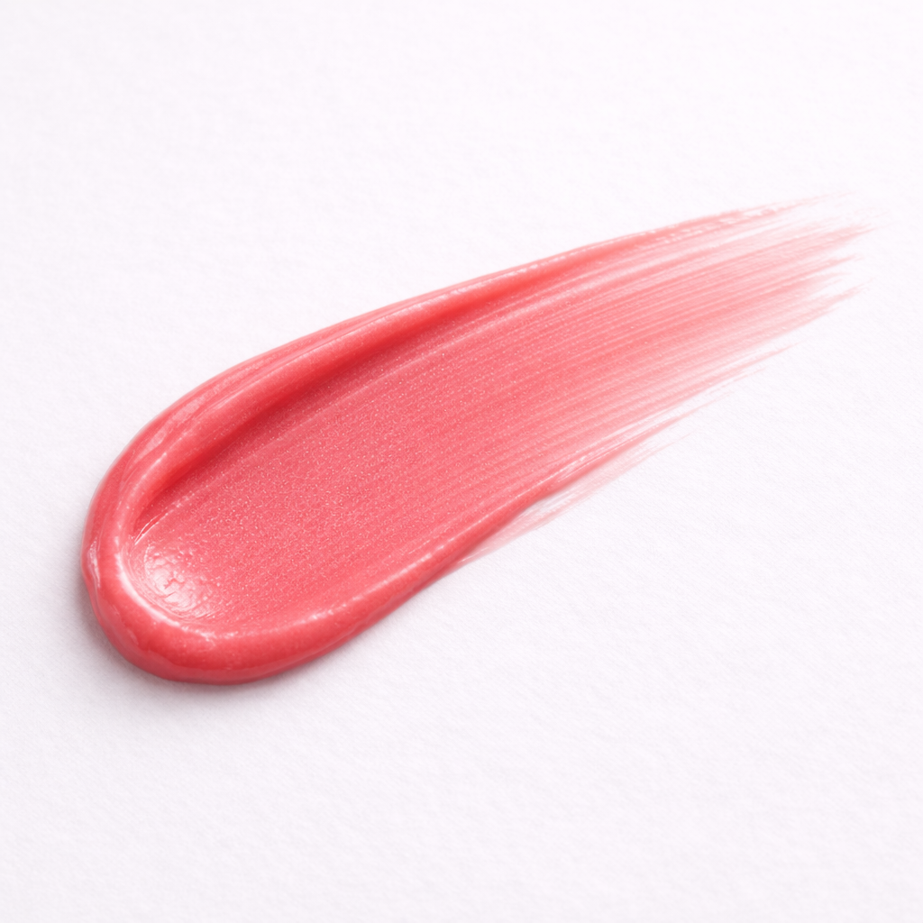 Swatch de baume lèvres et joues Watermelon montrant une texture crémeuse et pigmentée sur fond gris clair
