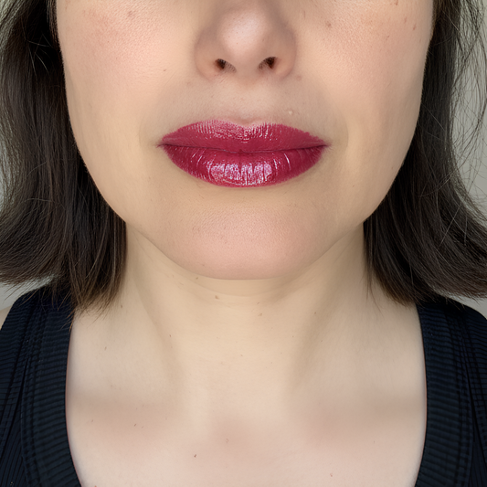 velvet Cherry lip gloss by Lisa Noto on a model for clean high-end e-commerce image with soft luminous light.