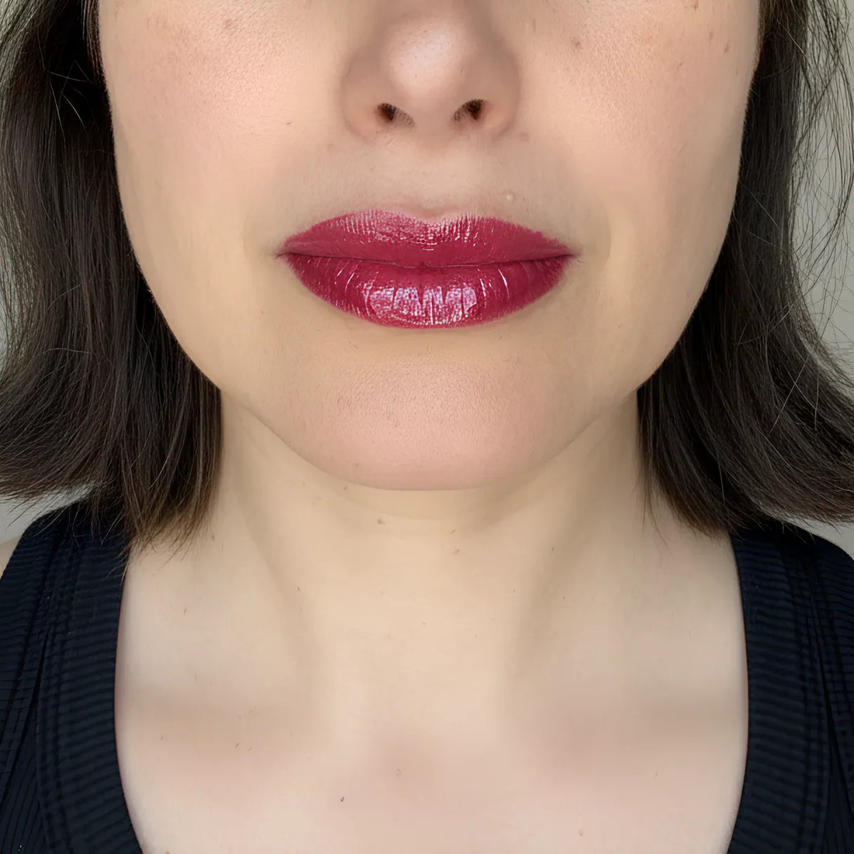 velvet Cherry lip gloss by Lisa Noto on a model for clean high-end e-commerce image with soft luminous light.