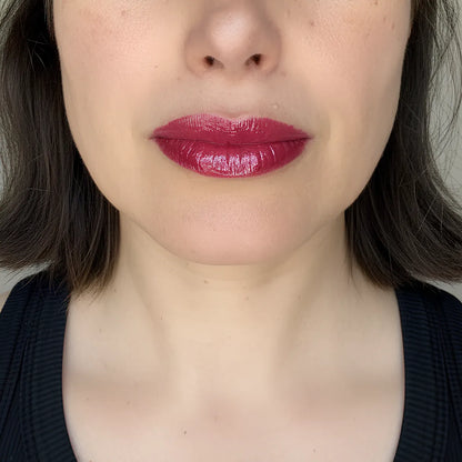 velvet Cherry lip gloss by Lisa Noto on a model for clean high-end e-commerce image with soft luminous light.