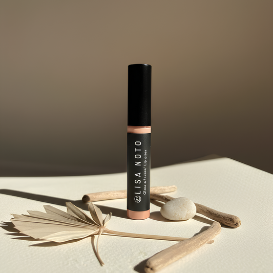 Lisa Noto Hydrating Nude Lip Gloss surrounded by natural elements, clean beauty aesthetic.